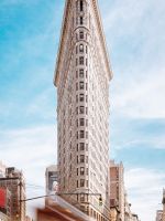 beige concrete building near cars wallpaper